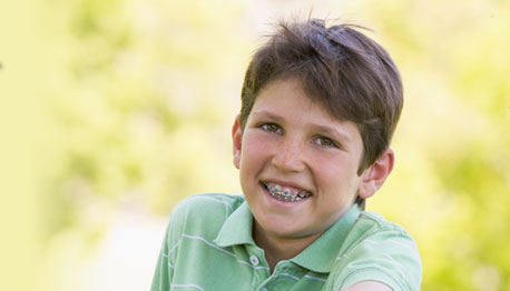 boy with braces smiling outdoors